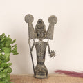 Decorative statue with intricate designs on a neutral background